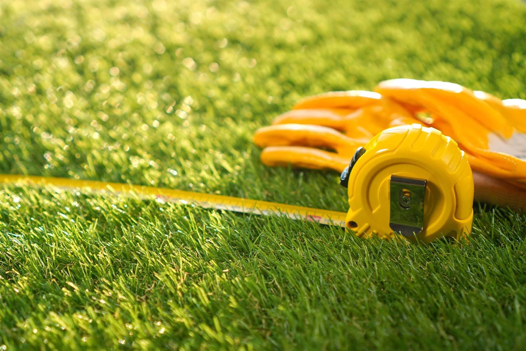 Tape measure extended across a natural lawn