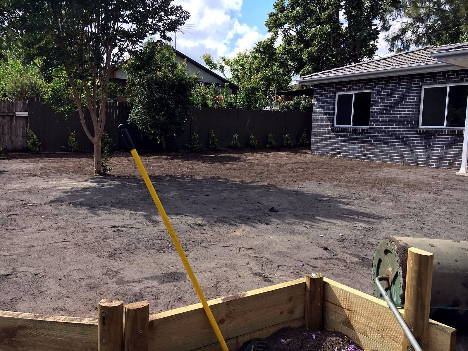 Prepared and levelled soil surface behind the timber lawn edge in Kellyville