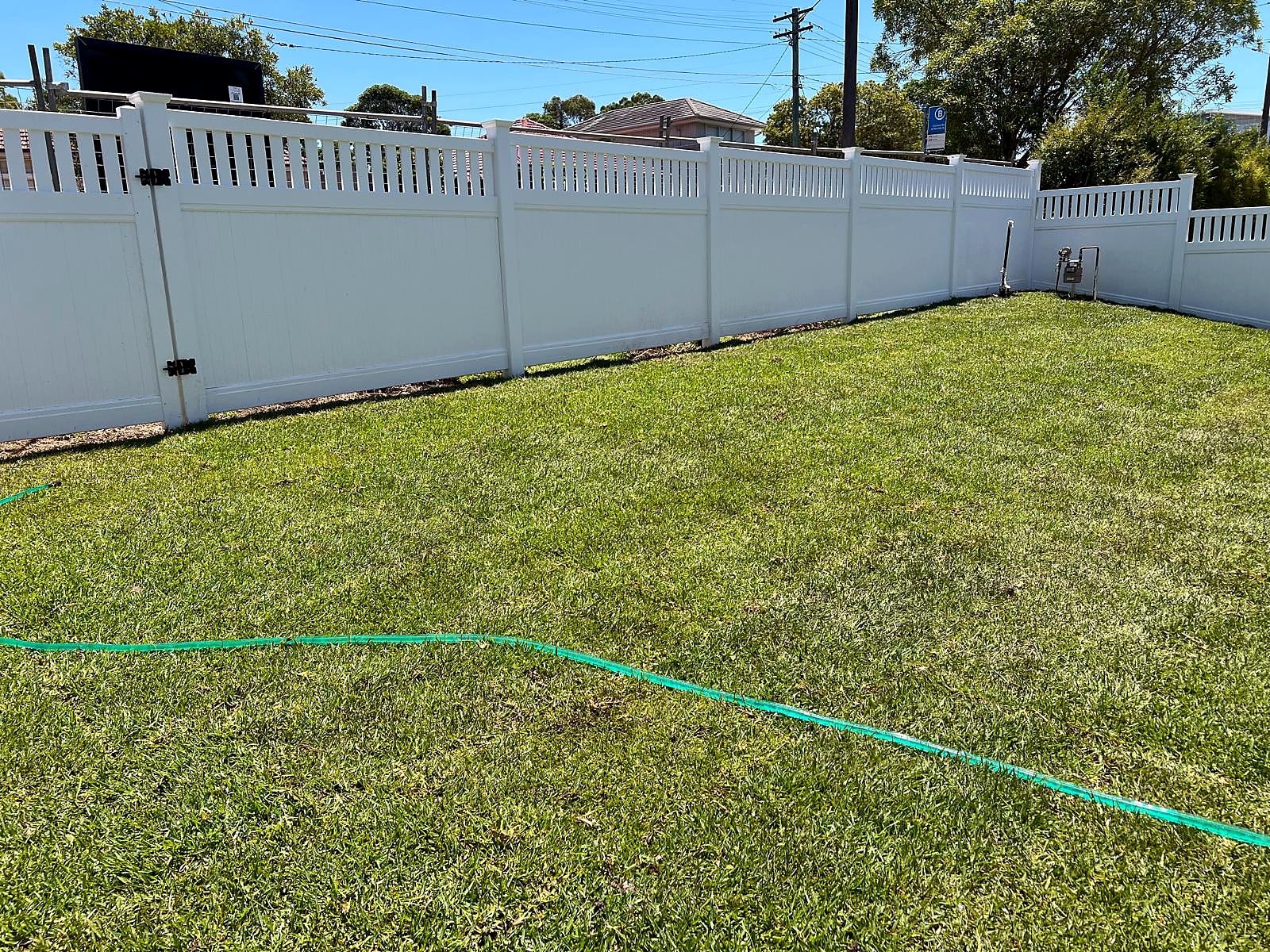 Completed natural turf across a broad Turramurra lawn beside a white fence