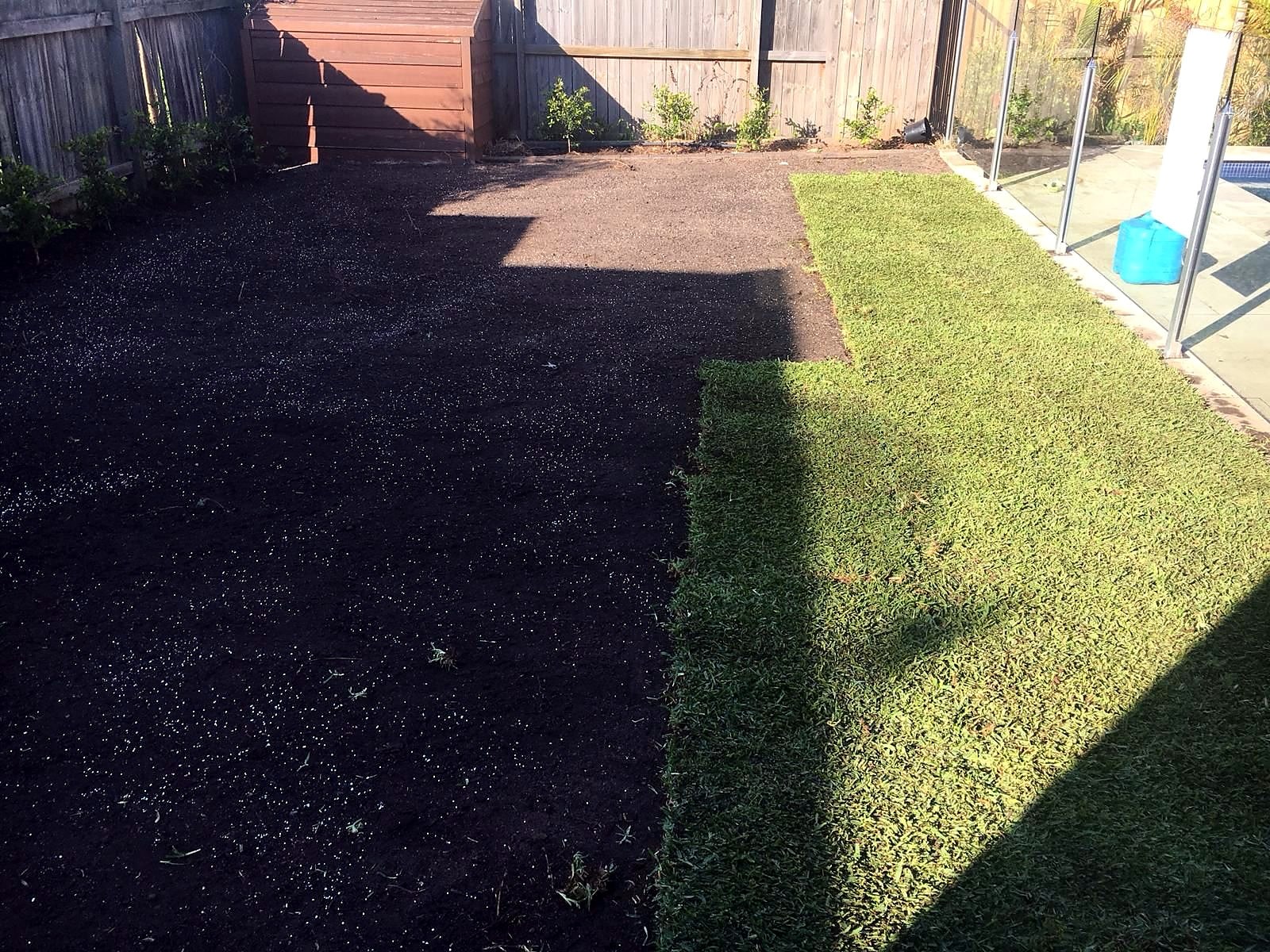 West Ryde side yard during turf laying beside the prepared soil area